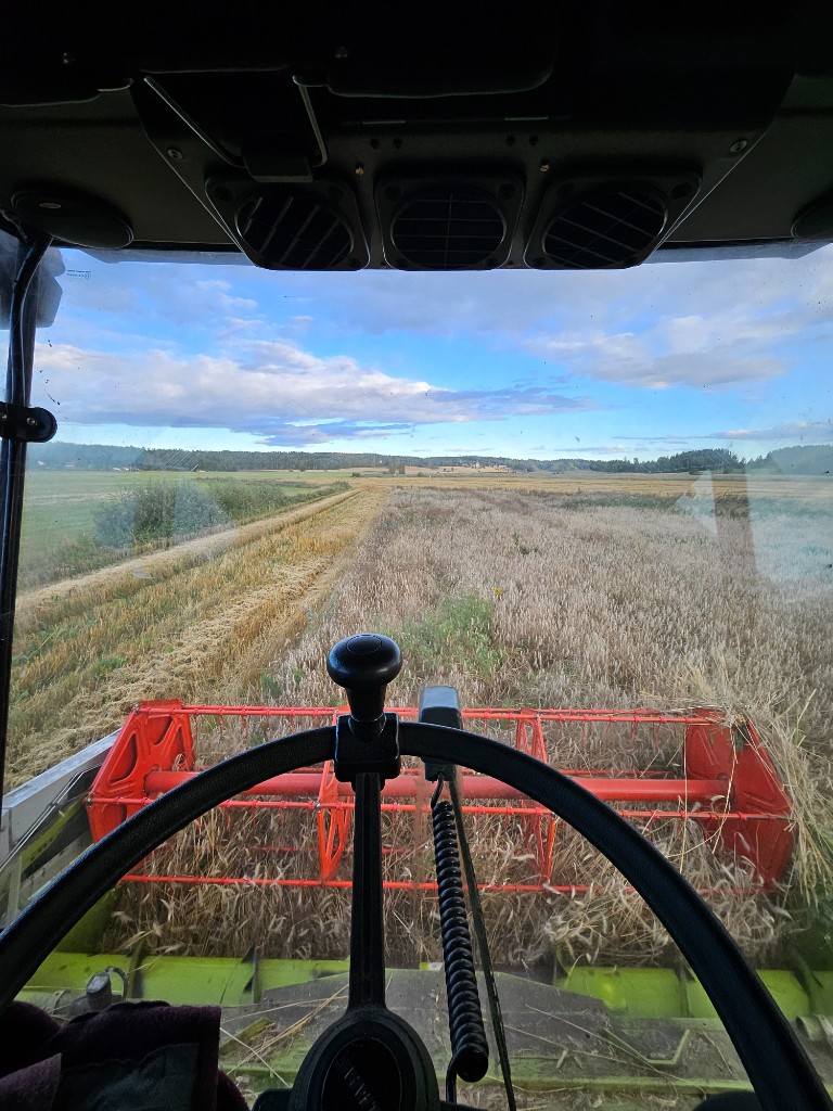 View from inside a combine harvester on a farm field