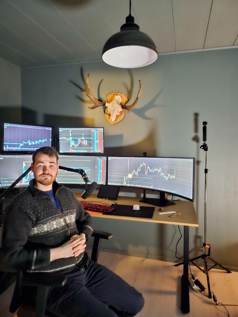 Joakim Jusell at his trading desk with multiple monitors showing futures charts and order flow